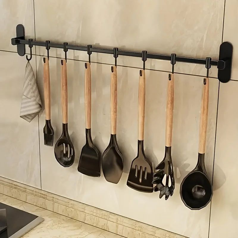1 estante de almacenamiento para utensilios de cocina, como tapas de ollas y espátulas, con ganchos de pared y múltiples opciones de almacenamiento para artículos de cocina