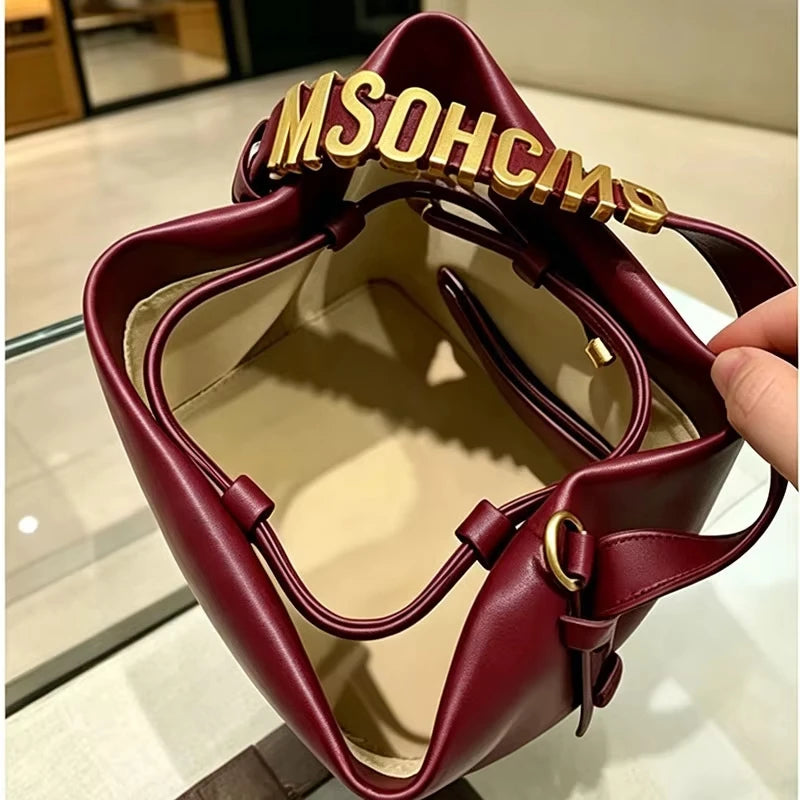 2026 New Light Luxury Drawstring Bucket Bag Trendy Gold Letter Handheld Crossbody Bucket Bag for Women Mini Shoulder Bag.