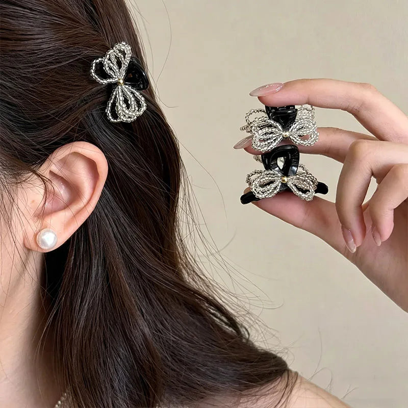 Two mini hair claw clips with beaded bow details, shown as a two-piece set.