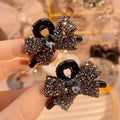 Two mini hair claw clips with rhinestone details, shown as a two-piece set.
