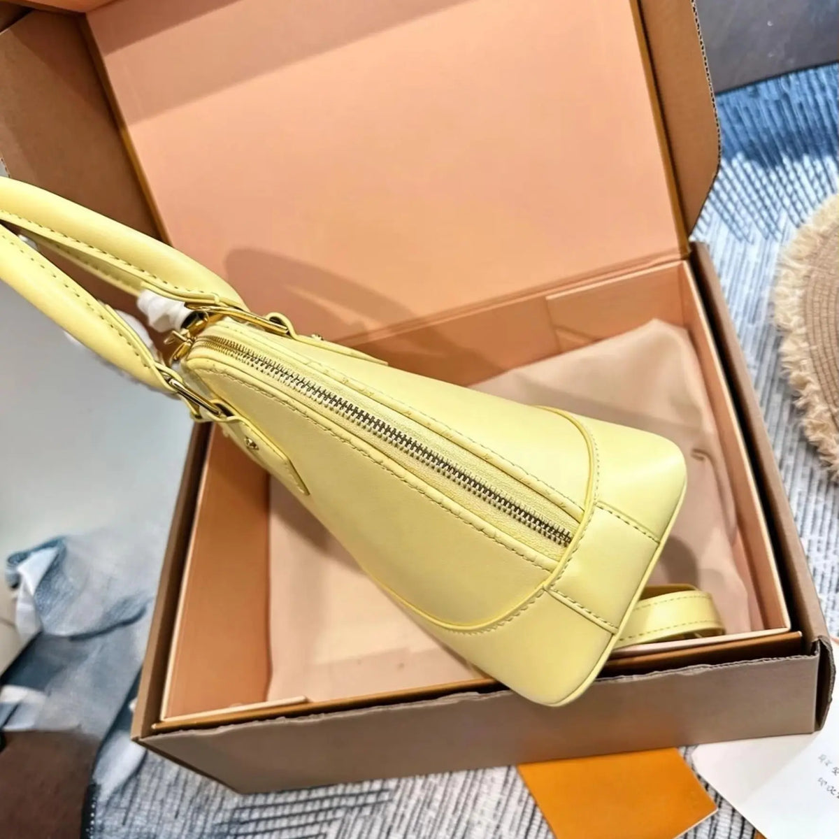 Yellow smooth calf leather handbag, with gold-tone lock hardware, top handle, detachable matching crossbody strap, small shell shoulder bag.